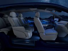 the interior of a car with its passenger seats folded down and lights on in the background