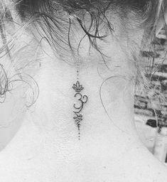 the back of a woman's neck with a tattoo on it