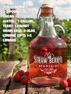 a bottle of strawberry syrup sitting on top of a wooden table next to strawberries