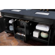 a bathroom vanity with two sinks and drawers