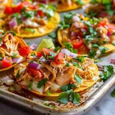 several tacos on a tray ready to be eaten with salsa and cilantro