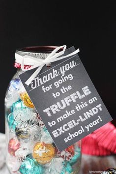 a jar filled with lots of candy and a sign that says thank you for going to the truffle to make this one excellent - lindt school year