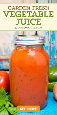 a jar filled with fresh vegetable juice on top of a blue table cloth next to vegetables