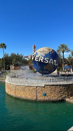 the universal studios sign is shown in front of a body of water