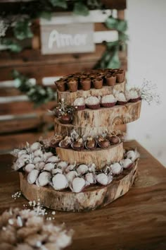 three tiered trays filled with different types of food on top of a wooden table