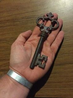 a person holding an old key in their hand