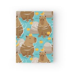 a notebook with an image of two beavers swimming in the water and rubber ducks floating around