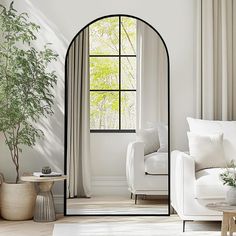 a living room filled with furniture and a large arched mirror next to a white couch