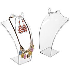 two clear acrylic jewelry stands with necklaces and earring holders on them