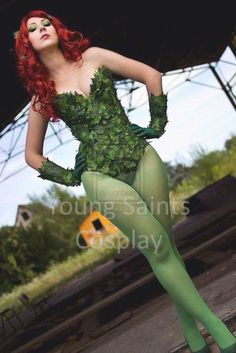 a woman dressed in green is posing for the camera