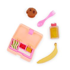 an open lunch box with fruit, ice cream and a banana next to it on a white surface