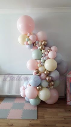 a bunch of balloons that are on the ground in front of a radiator