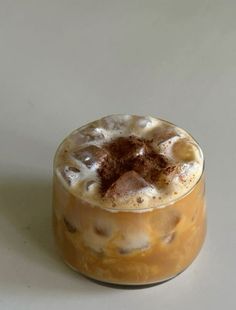 an iced drink in a glass on a white table