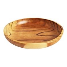 a wooden bowl sitting on top of a white surface