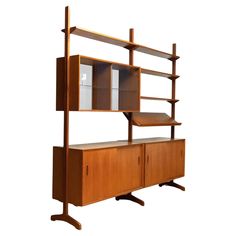 a wooden bookcase with two shelves and cupboards on it's sides, against a white background