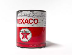 an old texaco can sitting on a white surface