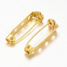 two pairs of gold colored metal clips