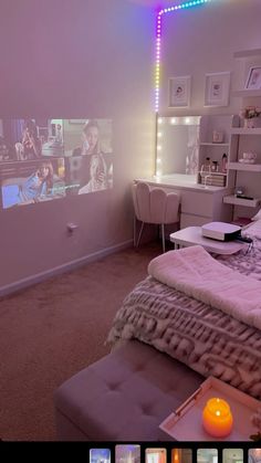 a bed room with a neatly made bed and a projector screen on the wall