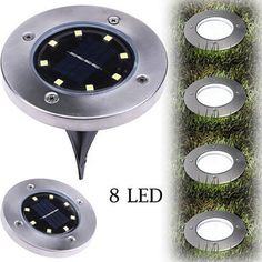 four solar powered lights on grass with the numbers 8 and leds in each light