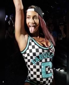 a woman with her tongue out at a concert