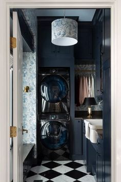 a black and white checkered floor in a laundry room with an open washer and dryer