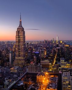 an aerial view of the empire building in new york city at night with lights on