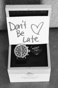 a black and white photo of a watch in a box with the words don't be late written on it