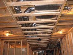 an unfinished room with exposed pipes and duct tape on the ceiling in order to prevent air flow