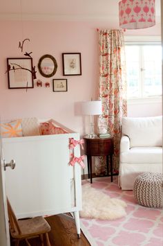 a baby's room is decorated in pink and white