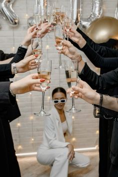 a group of people holding up wine glasses