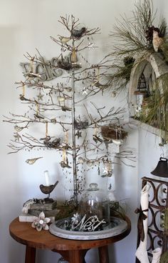 a christmas tree with ornaments on it in front of a mirror and other decor items