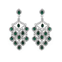 Elegant Art Deco inspired oval cut emeralds and diamond platinum chandelier earrings. These earrings are crowned with oval cut emeralds 12.09 carat in total. They are accented by round cut diamonds 9.79 carat in total. Diamonds are white and natural and in G-H Color Clarity VS. 18 karat white gold. French / Omega clips. Width: 3 cm Height: 7.5 cm Weight: 37.5 g