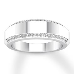 a white gold wedding ring with diamonds on the outside and in the middle, against a white background