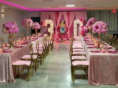 the tables are set up with pink and gold decorations