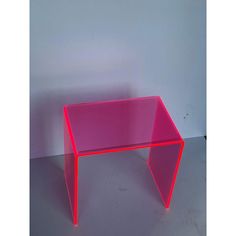 a pink table sitting on top of a white floor