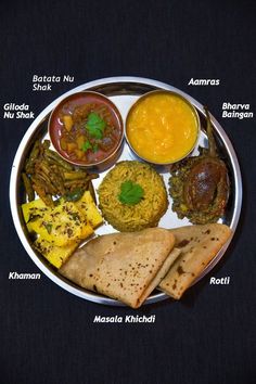 a plate filled with different types of food on top of a black tableclothed surface