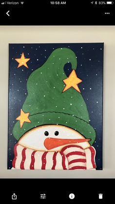 a painting of a snowman wearing a green hat and scarf with stars on it