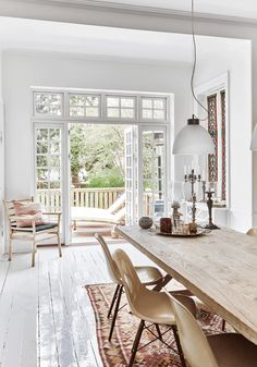 a dining room table with chairs and an area rug on the floor next to it