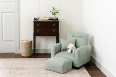 a chair with a stuffed animal sitting on it in front of a dresser and door