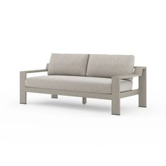 a gray couch with two pillows on it's back and one arm extended to the side