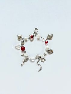 This handmade beaded charm bracelet is a simple but chic addition to any outfit. The bracelet features high quality glass beads and stainless steel charms, making it durable and non-tarnish. The red and silver accents offer a stylish and classic look. Bead Charm Bracelet, Red Bead, Silver Accents, Classic Looks, Bracelet Making, Bead Charms, Charms, Favorite Jewelry, Glass Beads