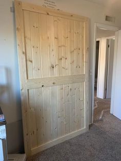 an empty room with wooden doors and carpet