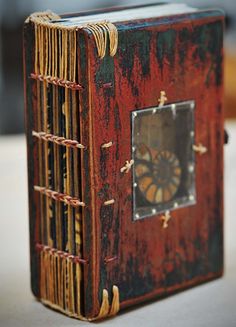 an old wooden box with a clock on the front and sides, sitting on a table