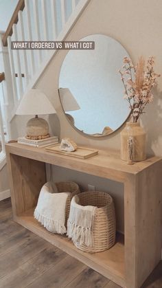 a mirror and some pillows on a wooden shelf in front of a stair case next to a staircase