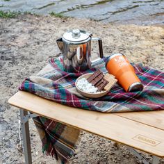 a picnic table with food and drink on it