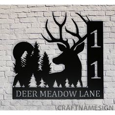 a metal deer sign on a brick wall