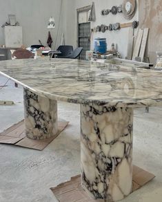 a large marble table sitting inside of a room