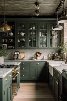 a kitchen with green cabinets and marble counter tops, along with wooden flooring that matches the ceiling