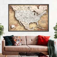 the united states map is hanging above a couch