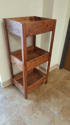 a wooden shelf sitting on top of a tiled floor